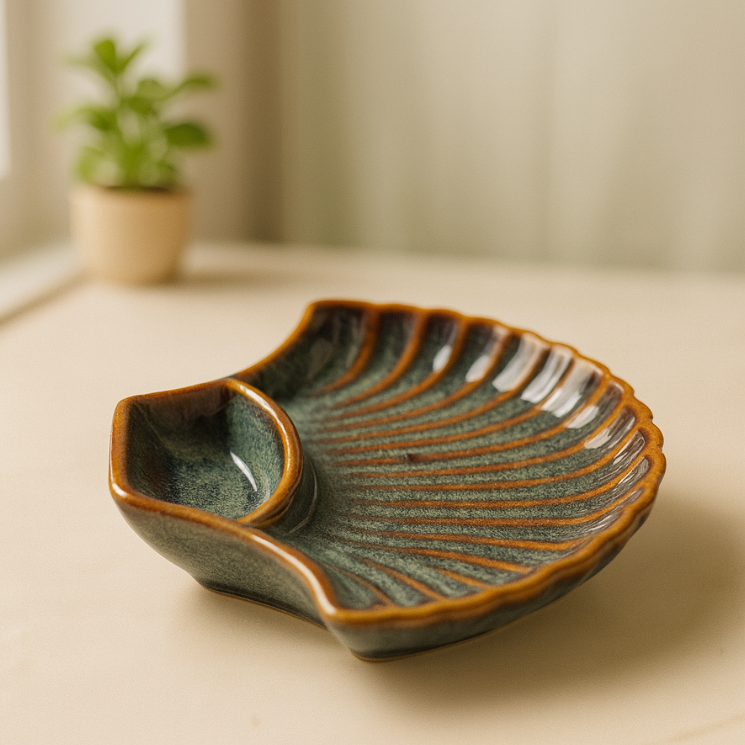 "Side view of artisanal shell-shaped ceramic plate highlighting glossy finish and ridged texture"