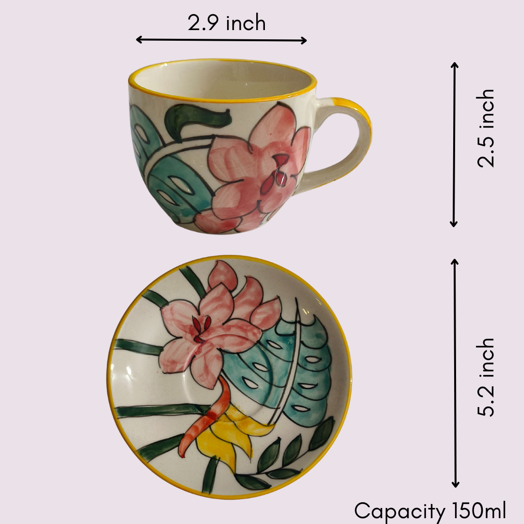 Close-up of handcrafted IndoCasa tea cup showing yellow rim and pink hibiscus floral detailing with a glossy finish