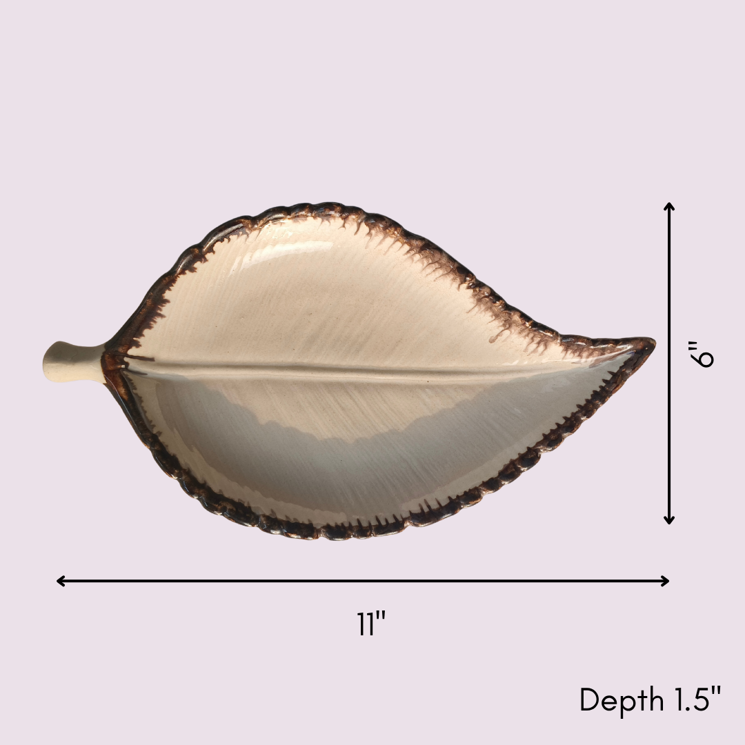 Top view of leaf-shaped ceramic platter with measurements — 11 inches long, 6 inches wide, 1.5 inches deep.