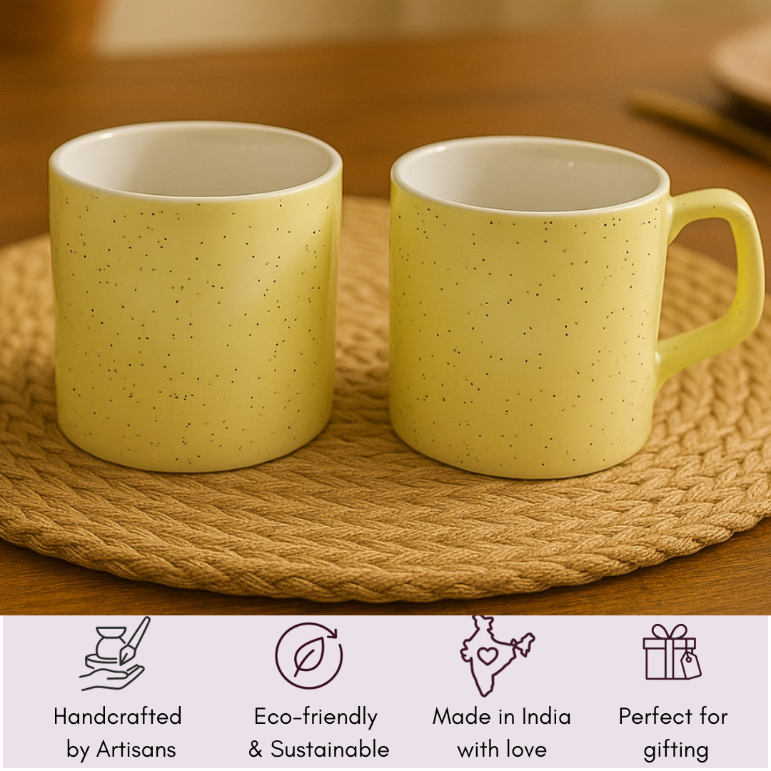 Two yellow mugs with icons showing handcrafted, sustainable, Made in India, and gifting-ready.