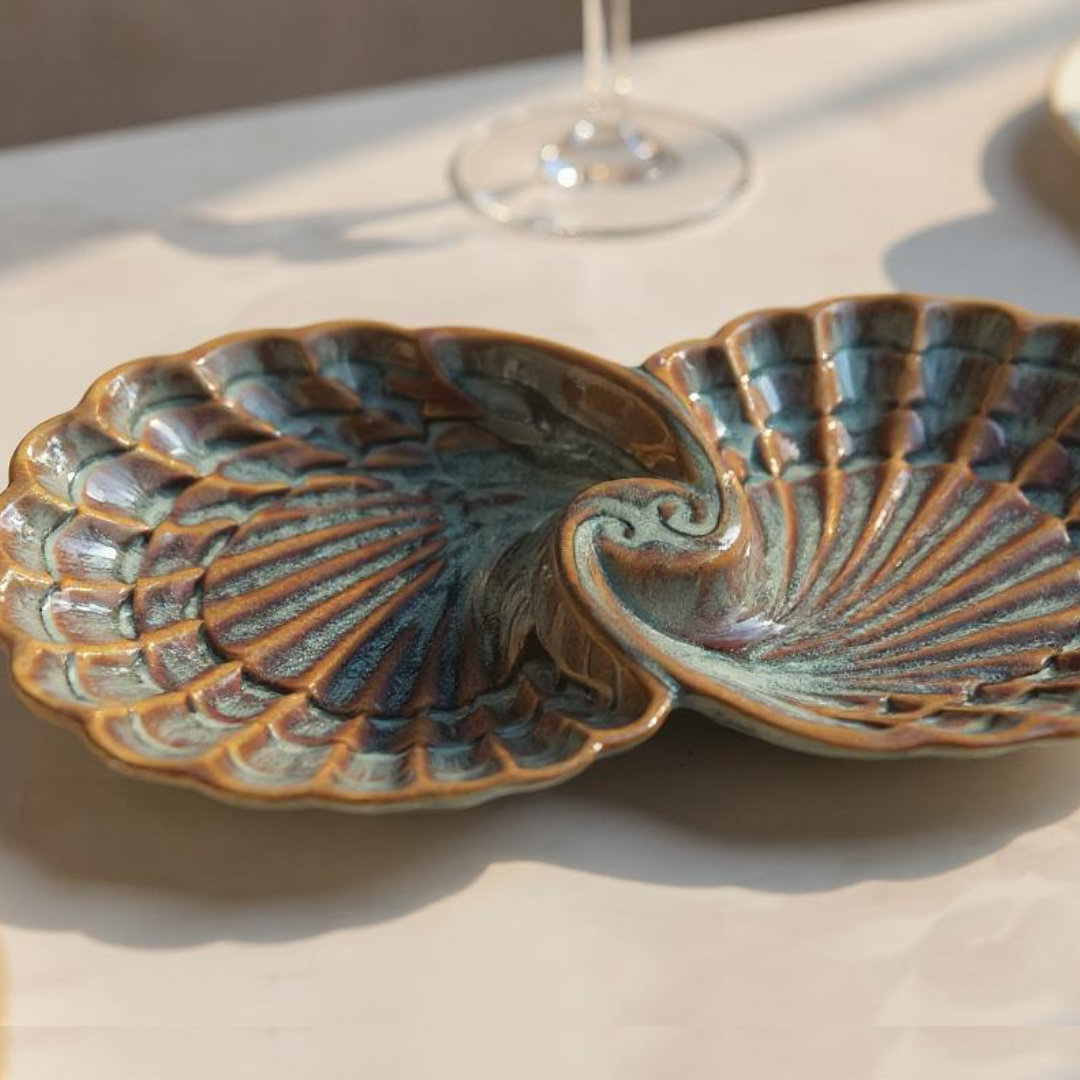 Top view of IndoCasa handcrafted shell-shaped ceramic platter with green rustic glaze

