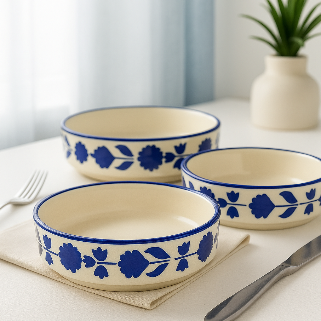 Three floral ceramic bowls arranged aesthetically near a window with natural light and minimal decor