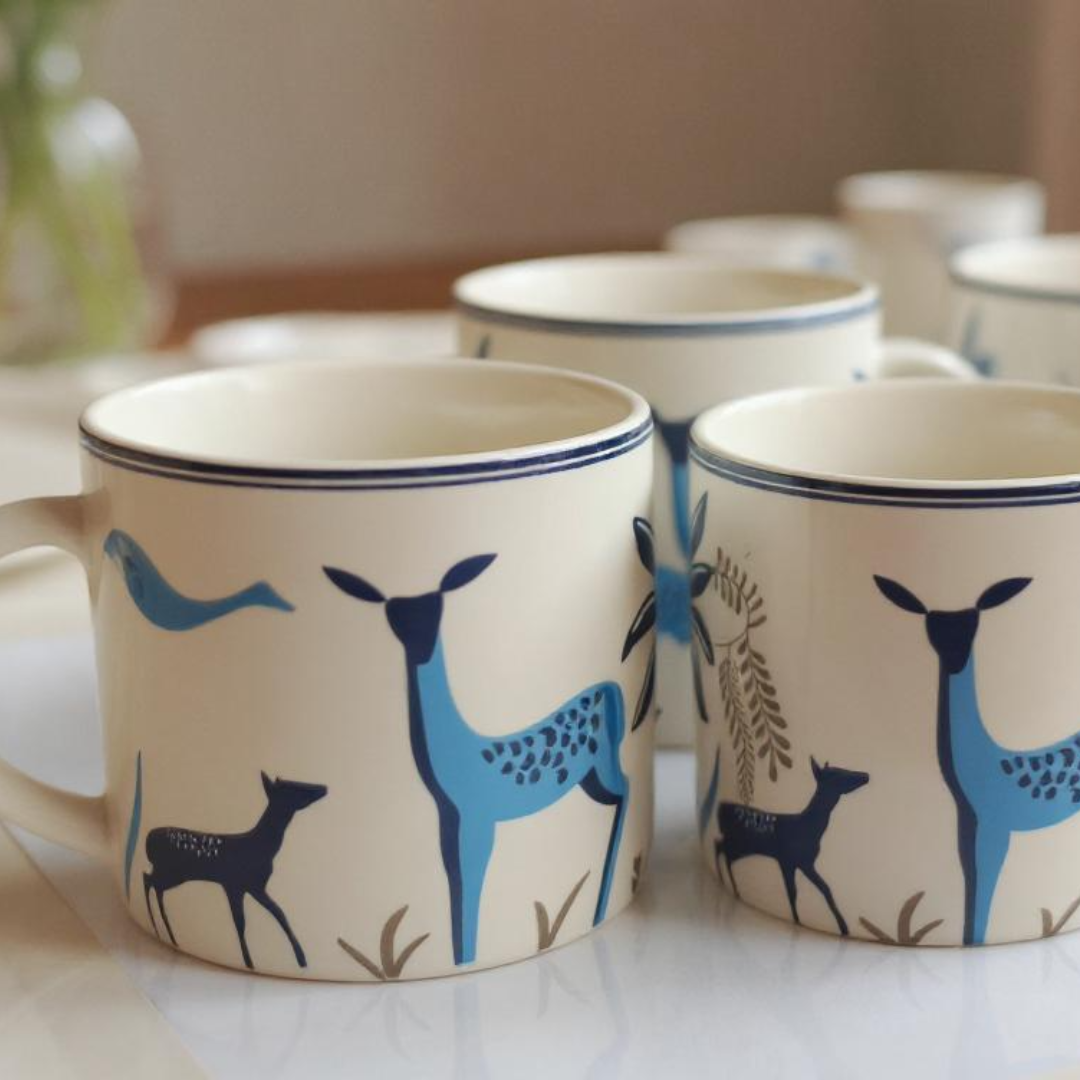 Set of six mugs in a warm, elegant dining setup